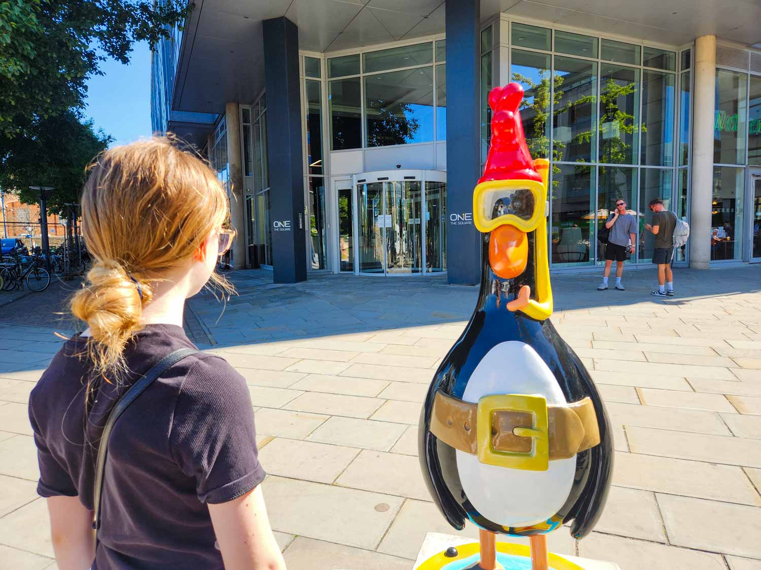 My daughter looks at a statue of Feathers McGraw with snorkel called Predator - my Gromit Unleashed 3 review of a visit to Bristol with kids