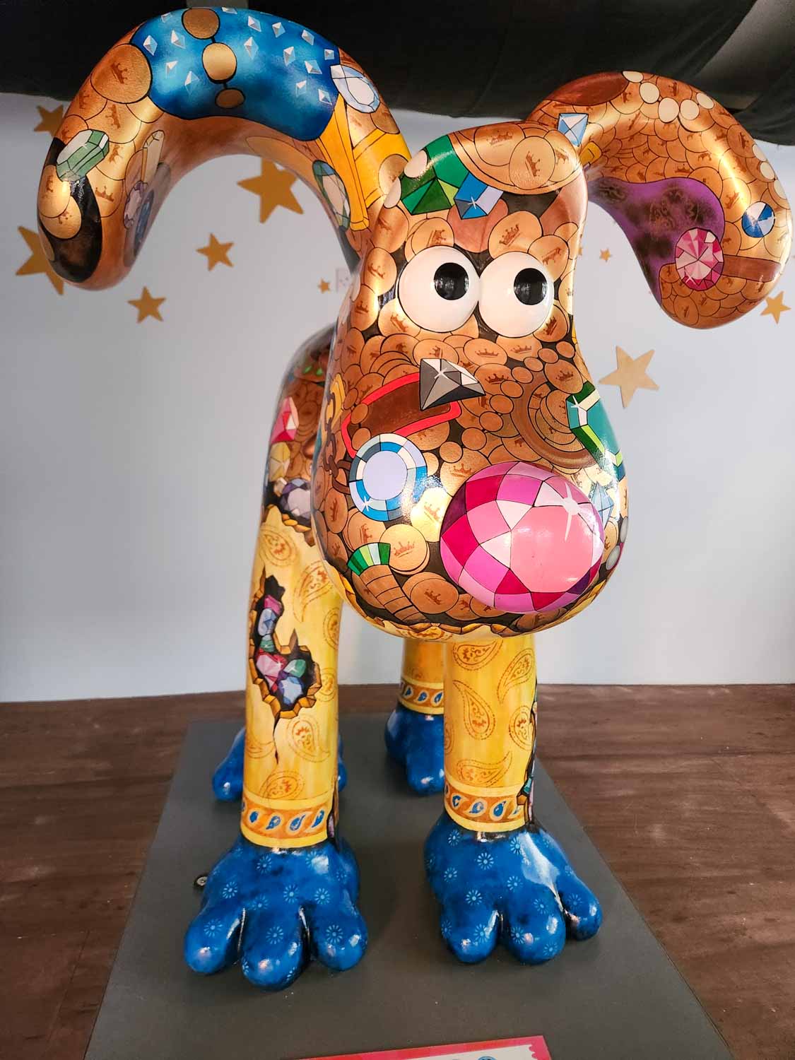Statue of Gromit decorated with gold coins and jewels like a treasure chest at St Nicholas Market in Bristol - my review of Gromit Unleashed 3