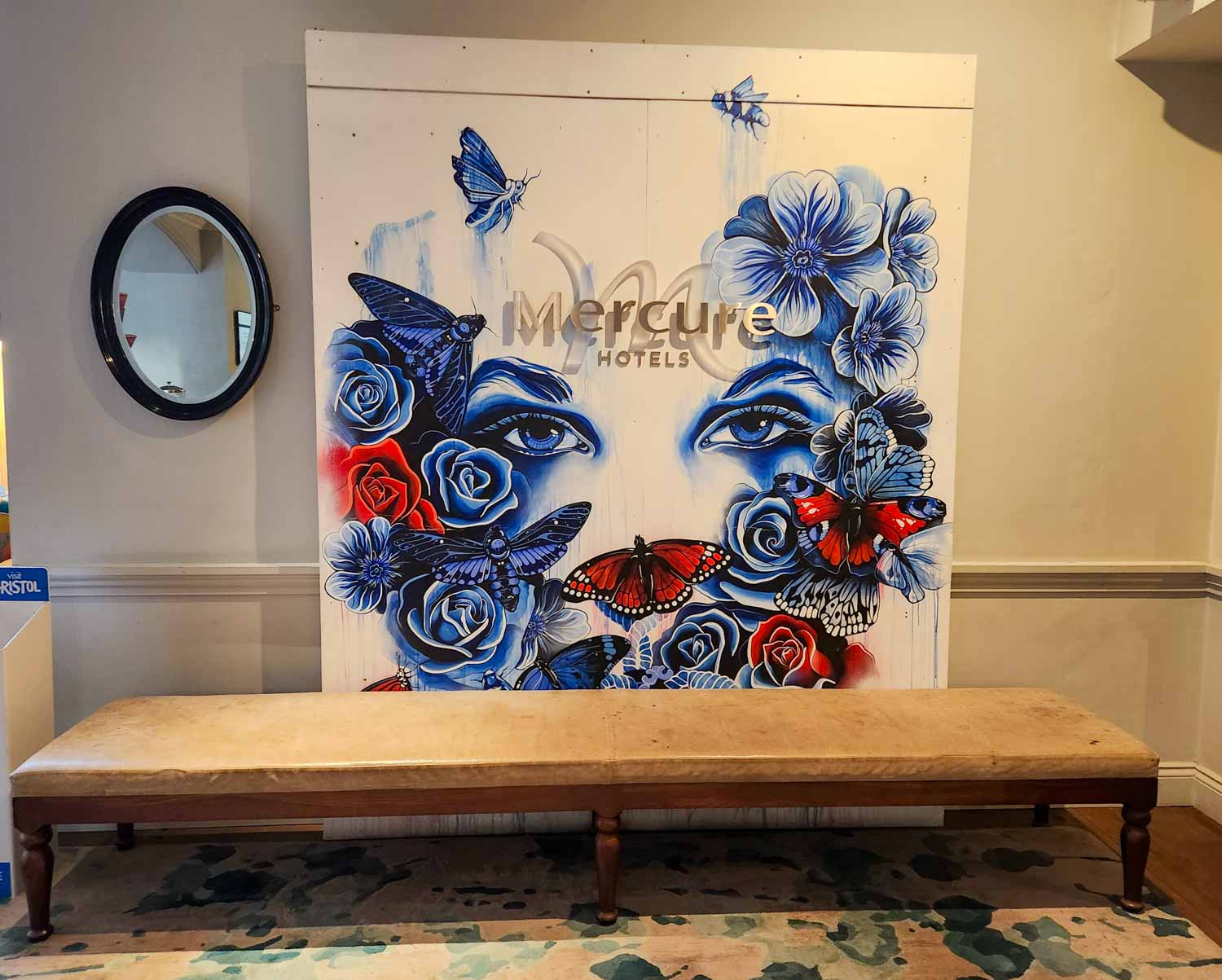 Artwork of a woman's eyes with blue and red flowers and butterflies around - my Mercure Grand Bristol hotel review