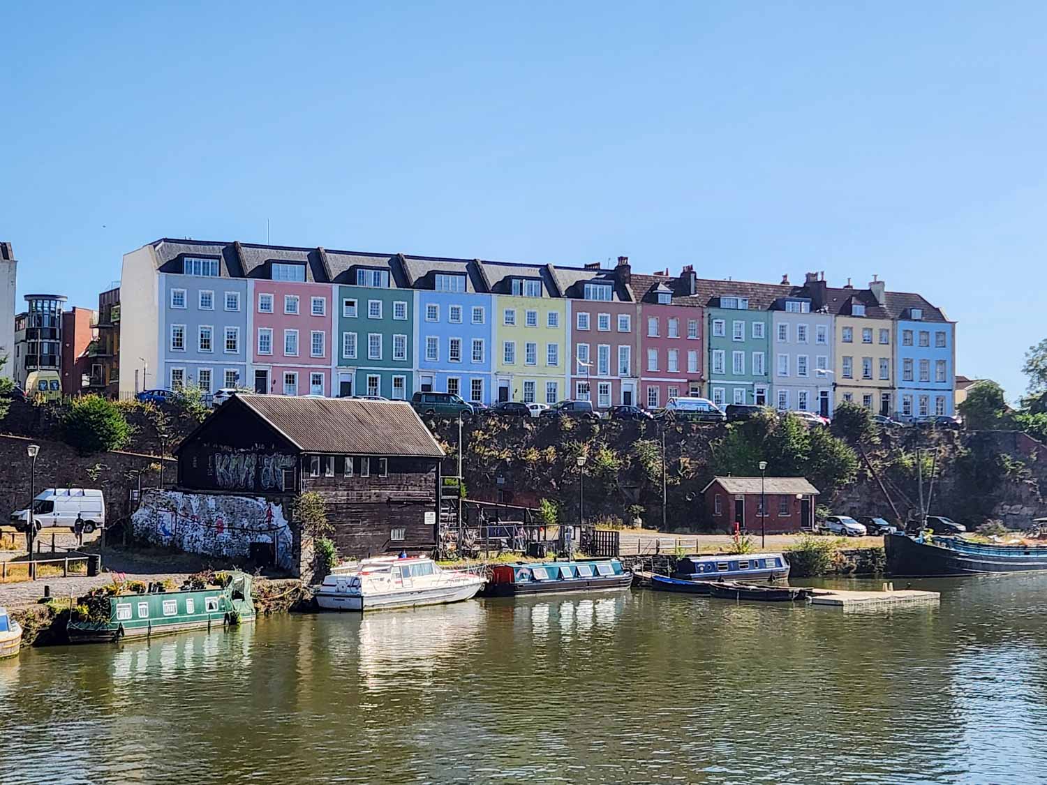 View of some of the colourful houses above the river during a weekend in Bristol with kids following the Gromit Unleashed 3 trail