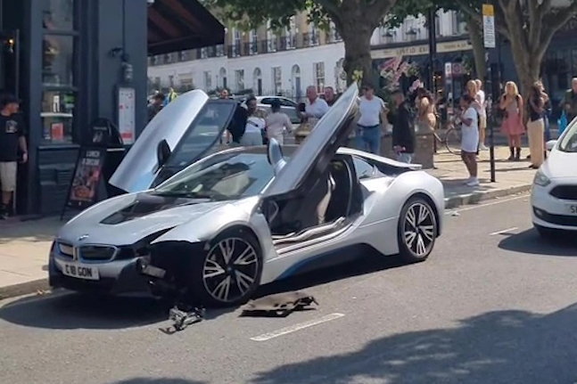 Damaged silver BMW i8 in a street brawl.
