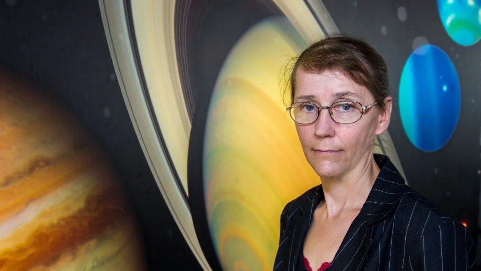 Portrait of Catharine Conley in front of a background depicting planets and space.