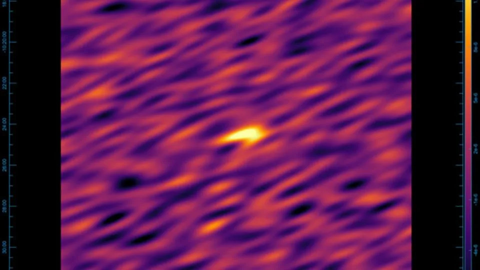 Shown above is the blurry image that left the astronomers scratching their heads, with the signal as a bright spot in the center. - Marcin Glowacki