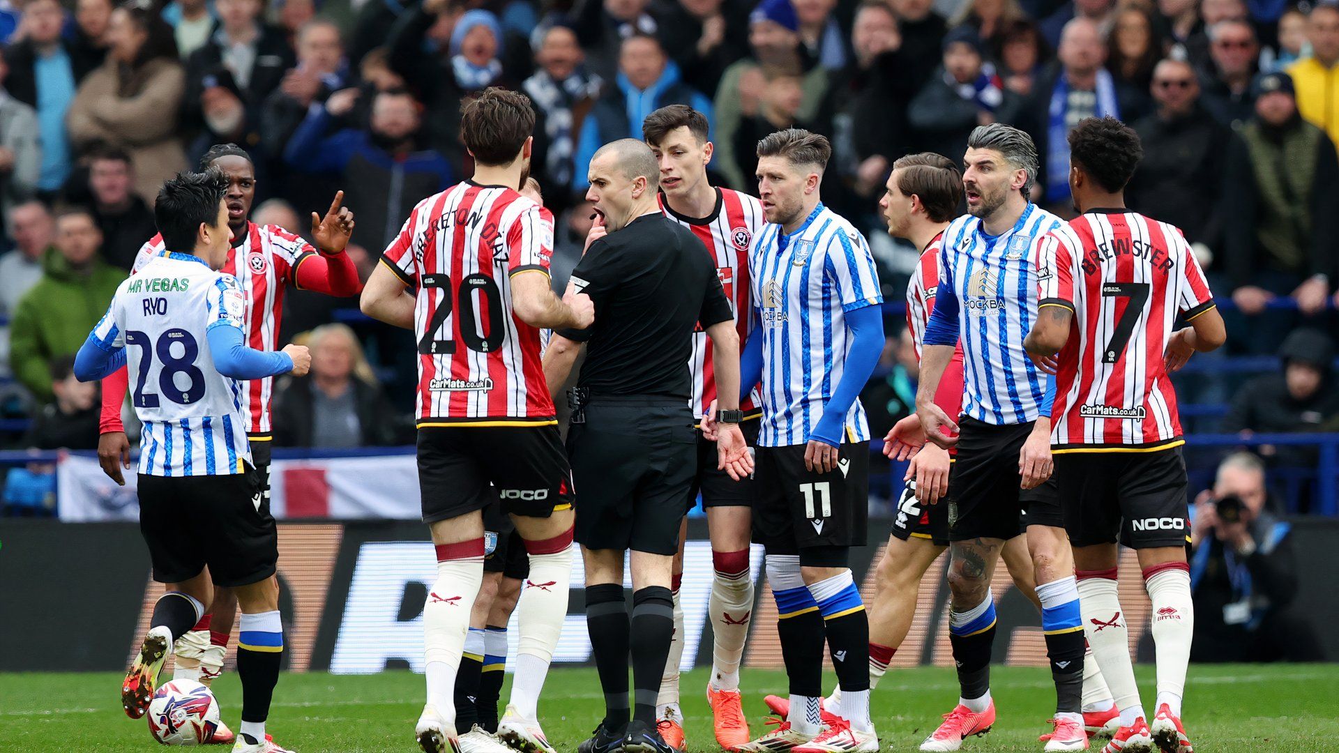 Sheffield Wednesday and Sheffield United players arguing with the ref 