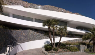 curved house's sinuous facade traces mountainous terrain in spain