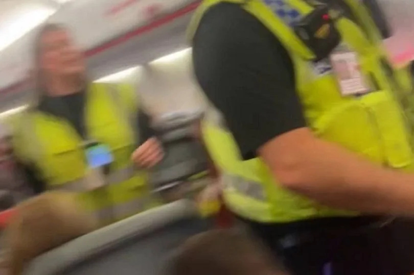 Two passengers were escorted off a plane by police at Leeds Bradford Airport after they became "uncontrollable" due to excessive vodka consumption, according to witnesses.