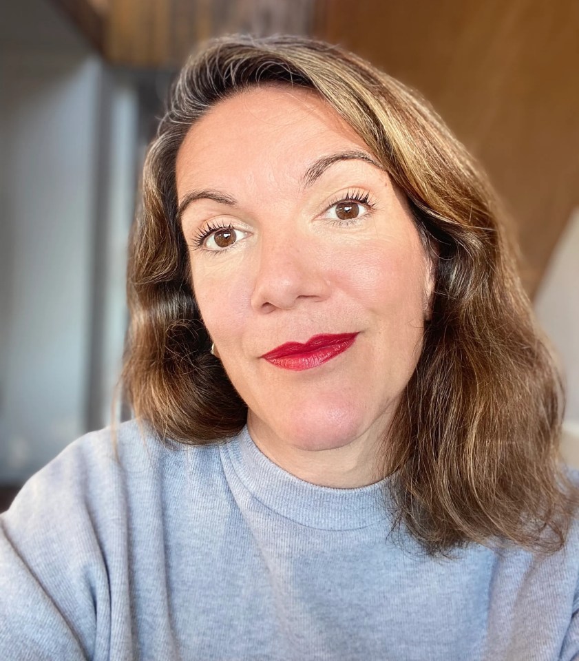 Headshot of a woman wearing a gray sweater.