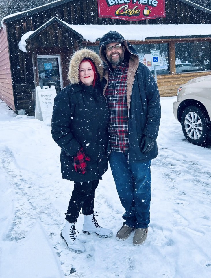 Couple standing in the snow outside the Blue Plate Cafe.