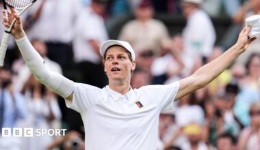 Jannik Sinner crouches to the ground after securing his first Wimbledon title