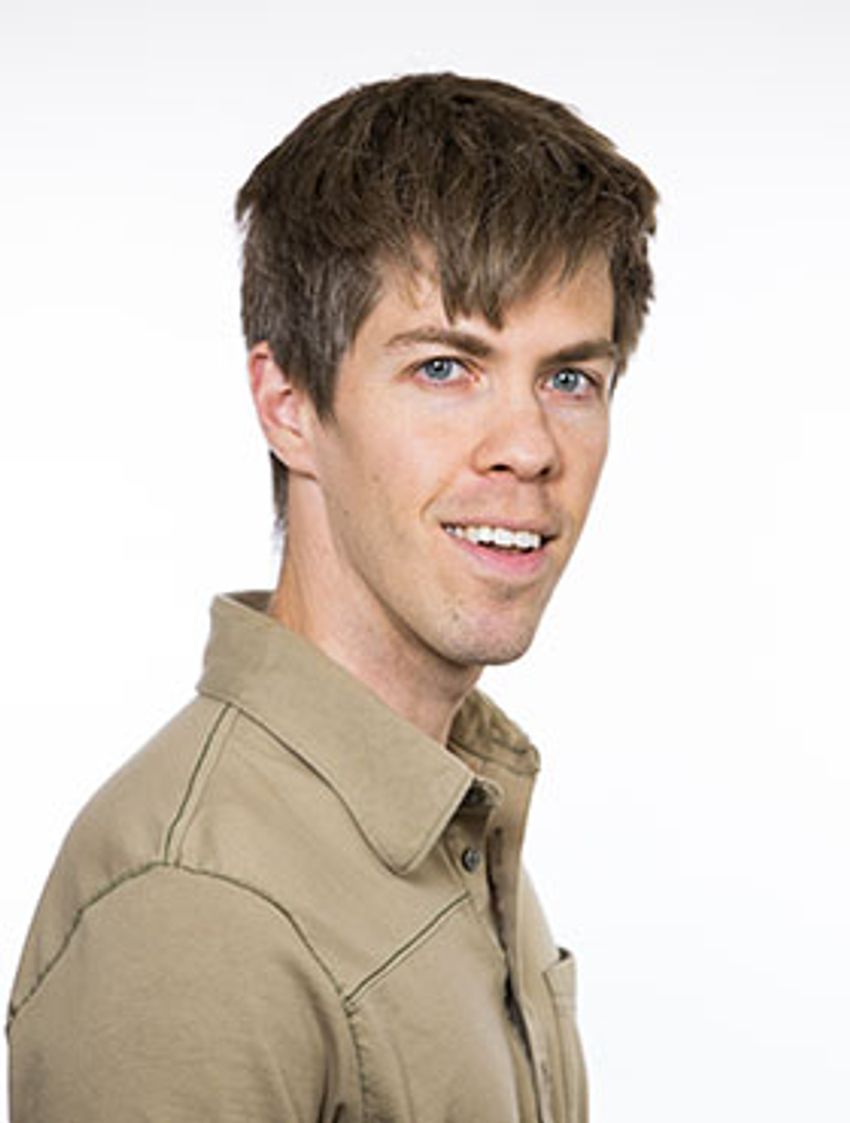 Photograph of Daniel Skelly, a statistical geneticist at The Jackson Laboratory. Skelly has short brain hair and is wearing a light brown, collared shirt.