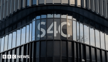 The S4C logo on the outside of its headquarters on a black building.