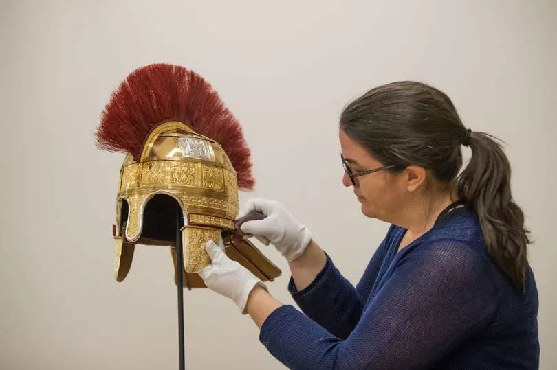 Conservator Pieta Greaves polishes a reconstruction of a Helmet found in the Staffordshire Hoard at the Birmingham Museum and Art Gallery, Birmingham -Credit:PA