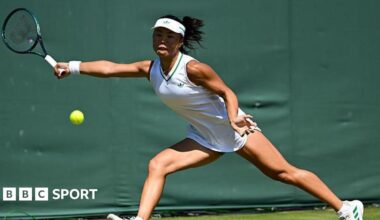 Mimi Xu returns a shot in the semi-finals of the girls' singles at Wimbledon