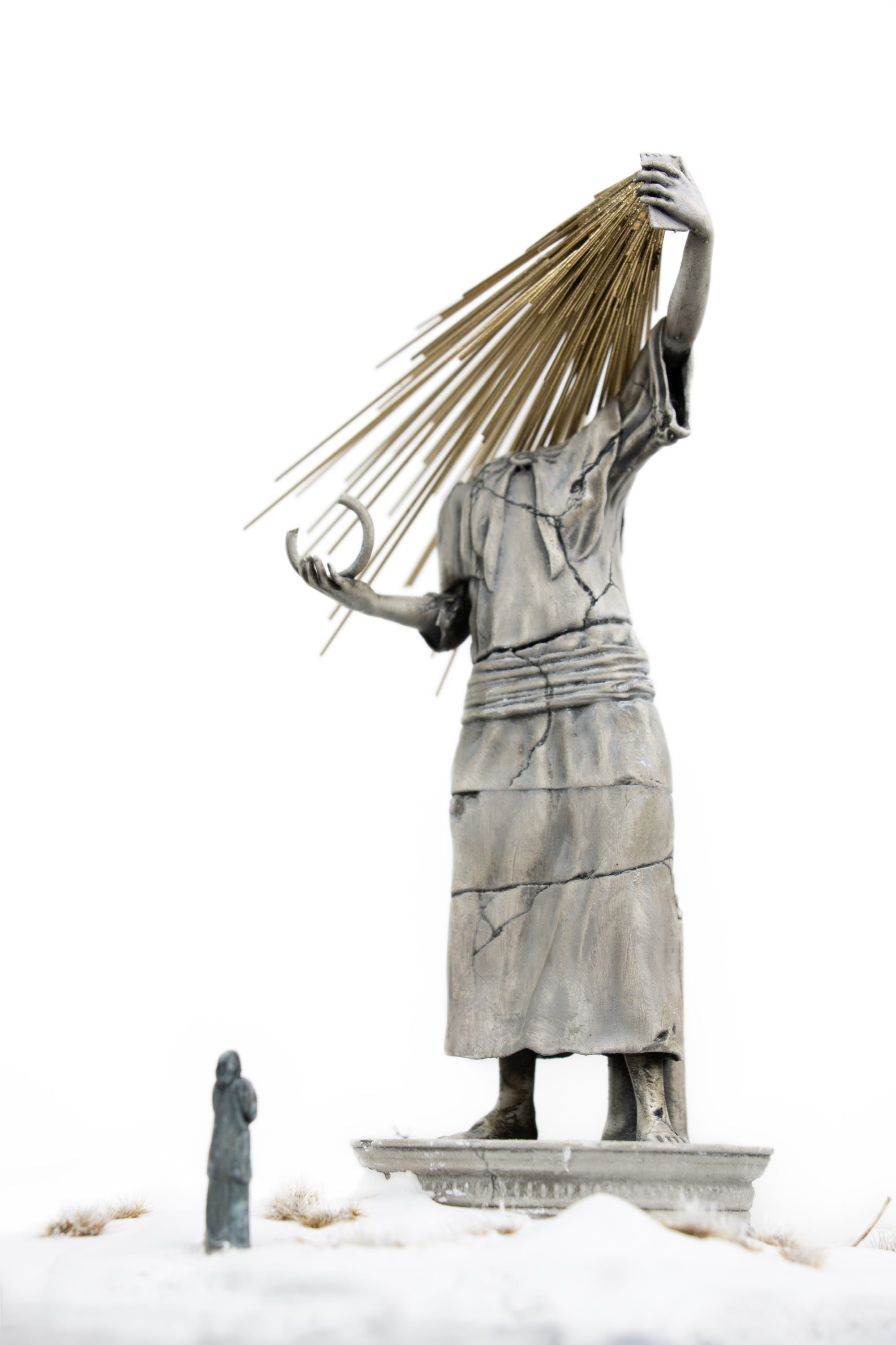 a miniature person looking at a figurative statue whose face melds into a phone