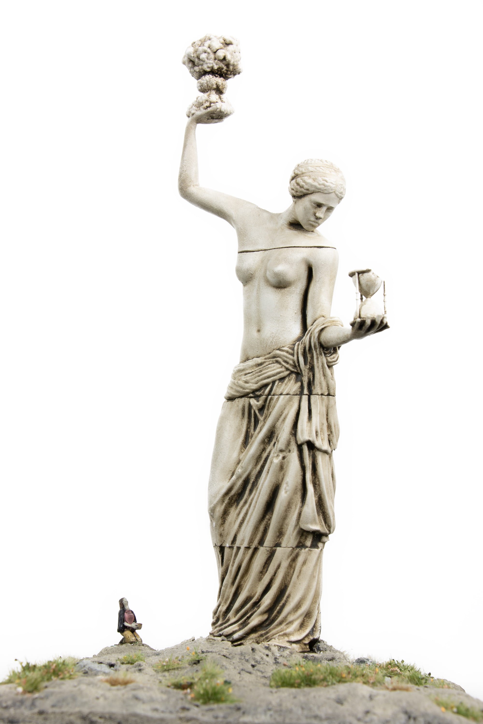 a miniature person sitting at the base of a figurative statue who holds an explosion in one palm and an hourglass in the other