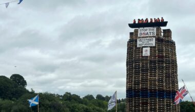 The migrant effigy had been hoisted atop a stories-tall stack of wooden pallets, one of hundreds of pyres lit each year in the run-up to July 12, a historically Protestant celebration (Peter MURPHY)