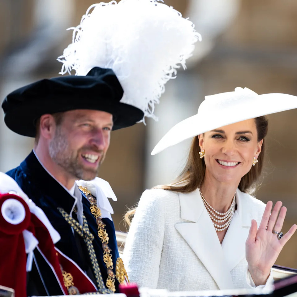  Kate Middleton and Prince William waving from a carriage . 