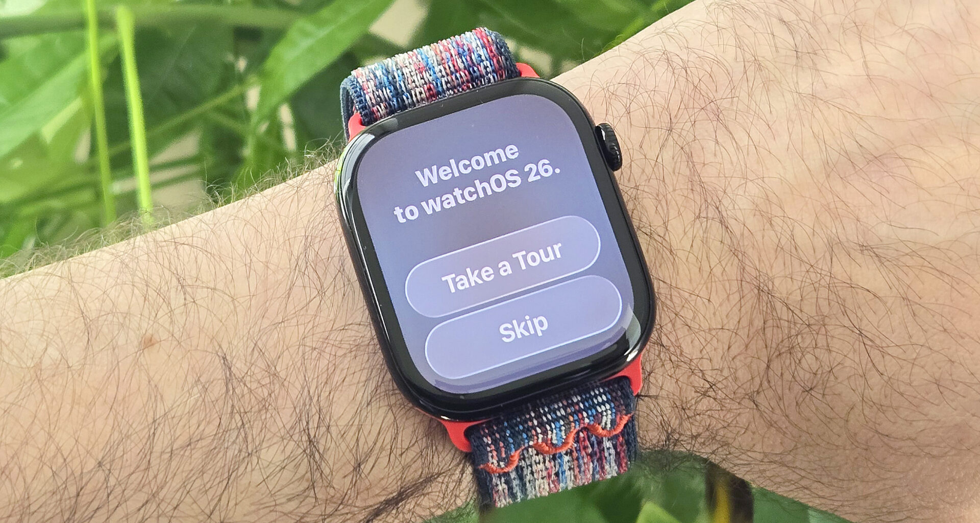 Close-up of an Apple Watch Series 10 on a user's wrist with a &quot;Welcome to watchOS 26&quot; message on display