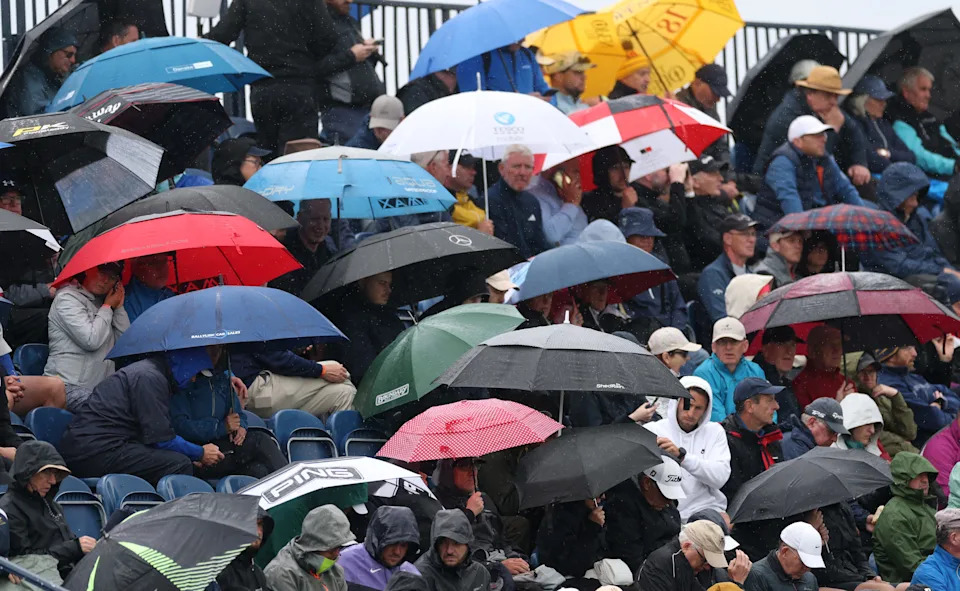 Jul 17, 2025; Portrush, IRL; Fans in the rain during the first round of The 153rd Open Championship golf tournament at Royal Portrush. Mandatory Credit: Mike Frey-Imagn Images