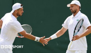 British pair Julian Cash and Lloyd Glasspool high-five after a point