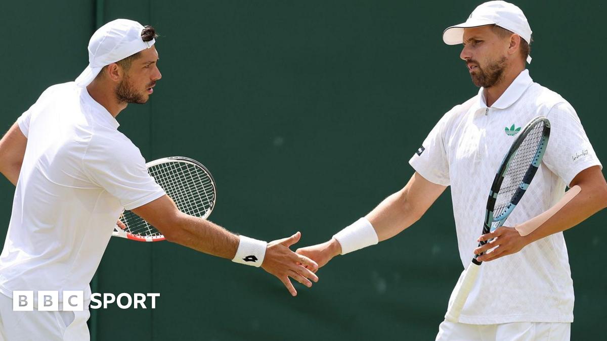 British pair Julian Cash and Lloyd Glasspool high-five after a point