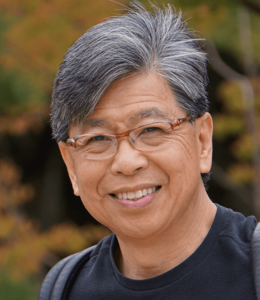 Photograph of Edison Liu, a cancer biologist at The Jackson Laboratory. Liu has short, salt-and-pepper colored hair, glasses with brown frames, and is smiling at the camera.