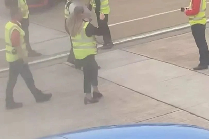 Two passengers were escorted off a plane by police at Leeds Bradford Airport after they became "uncontrollable" due to excessive vodka consumption, according to witnesses.