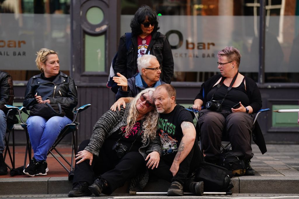 Fans arriving early to get their spot near the Black Sabbath Bridge bench on Broad Street in Birmingham ahead of funeral procession for Black Sabbath frontman Ozzy Osbourne through the streets of Birmingham, following his death last week aged 76. Picture date: Wednesday July 30, 2025. (Photo by Jacob King/PA Images via Getty Images)