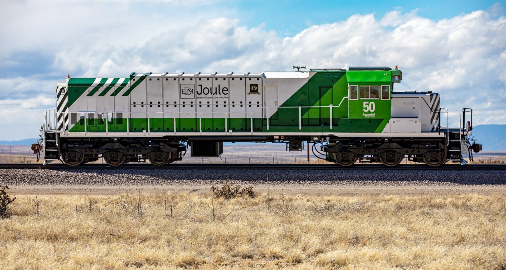 A low angle photo of a train engine without cars attached.