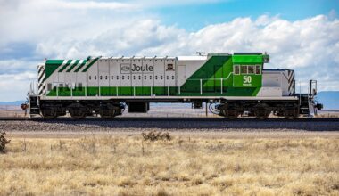 A low angle photo of a train engine without cars attached.