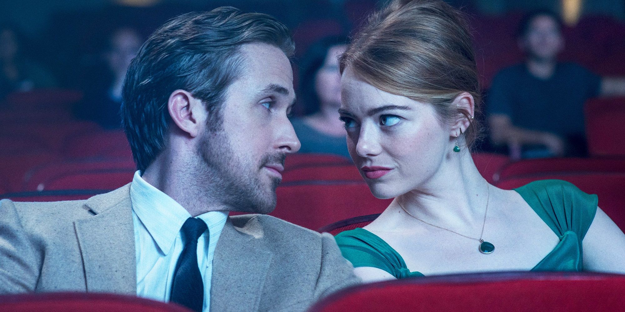 Emma Stone as Mia and Ryan Gosling as Sebastian in a movie theater in La La Land