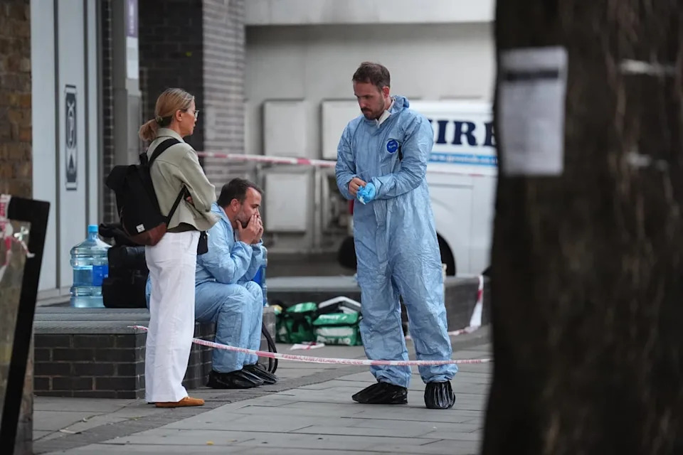 Forensic officers at the scene in Long Lane (James Manning/PA)