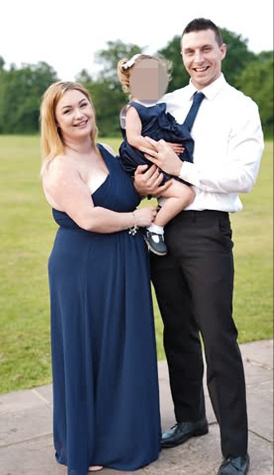 Family portrait: a woman in a blue dress, a man in a suit, and a young child.