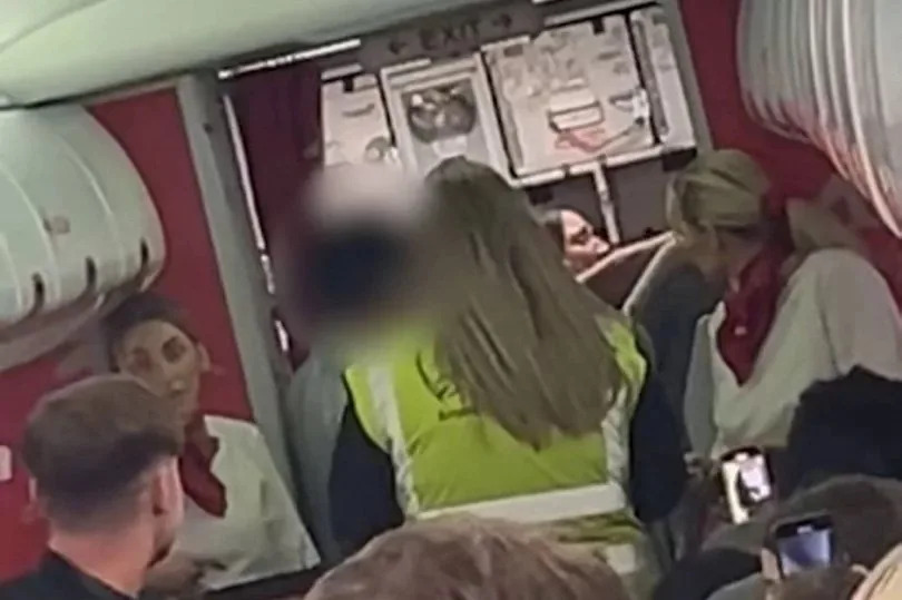 Two passengers were escorted off a plane by police at Leeds Bradford Airport after they became "uncontrollable" due to excessive vodka consumption, according to witnesses.
