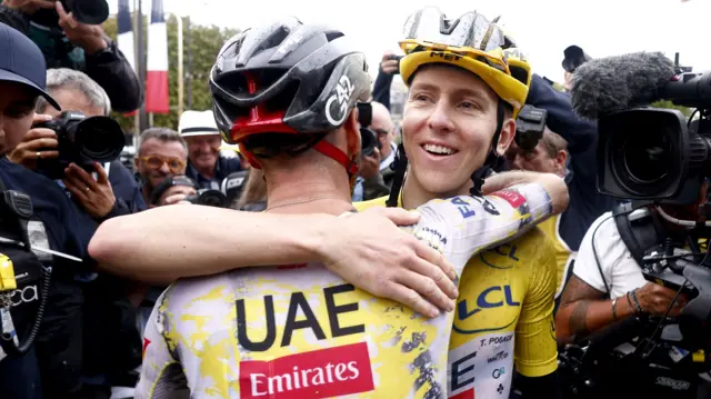 Tadej Pogacar hugs a UAE Emirates-XRG team-mate after winning the 2025 Tour de France
