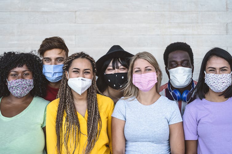 A group of young people wearing masks.