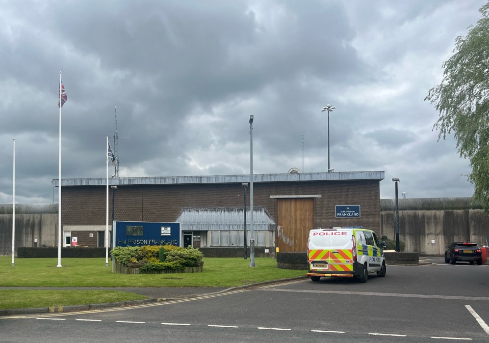 Photo of HMP Frankland prison in Durham, UK, with a police van outside.