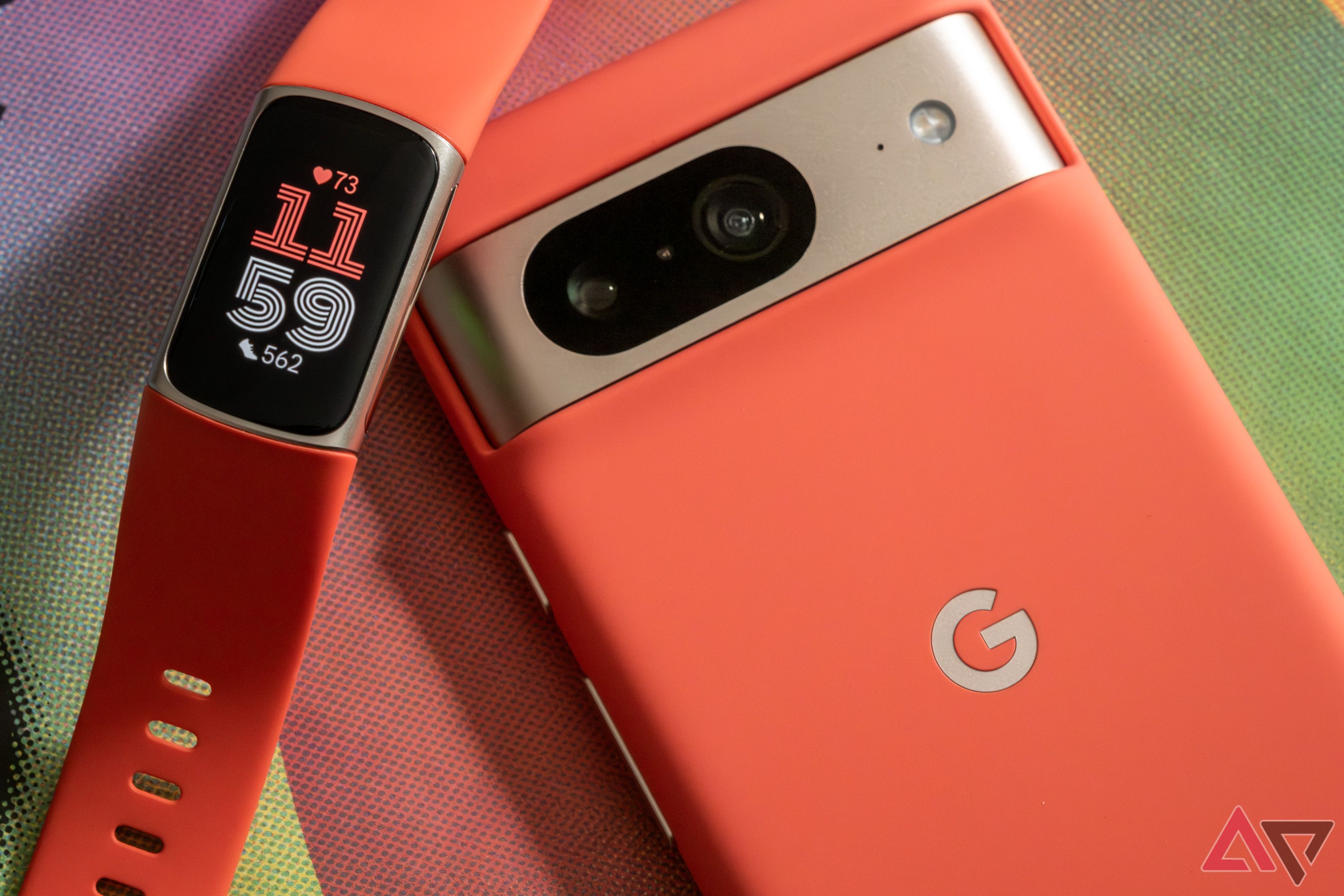The Fitbit Charge 6 next to a Google Pixel 8