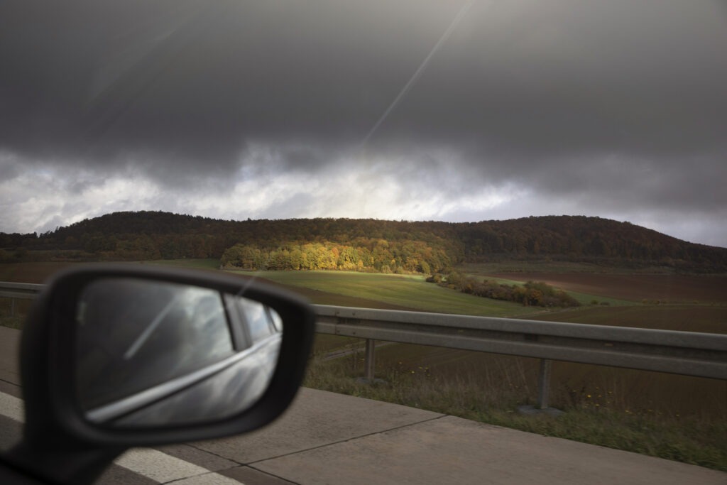 a car driving on a road in Germany with cloudy skies