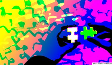 hands holding jigsaw pieces, colorful abstract background