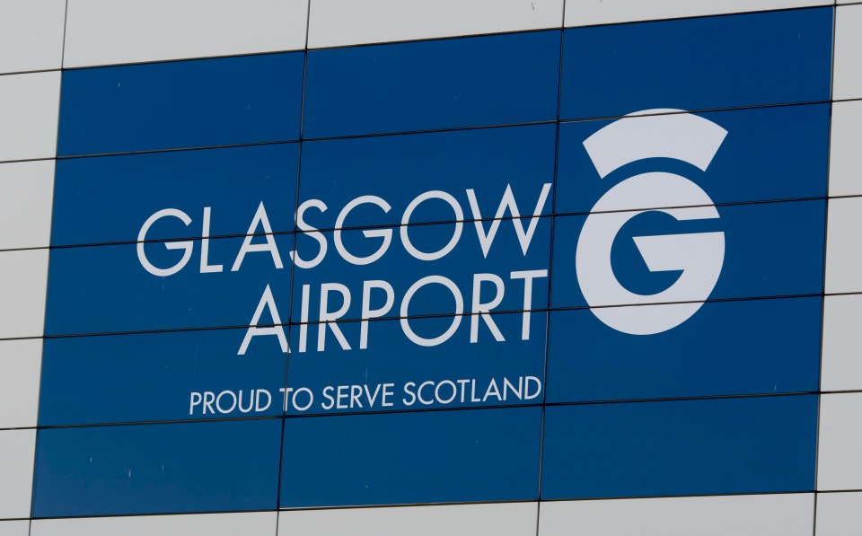 Glasgow Airport sign on a building.