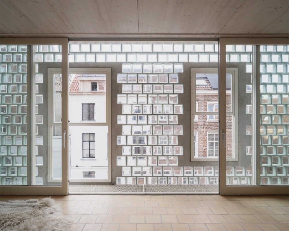 delmulle delmulle's gradient brick facade shifts from terracotta to glass in amsterdam house