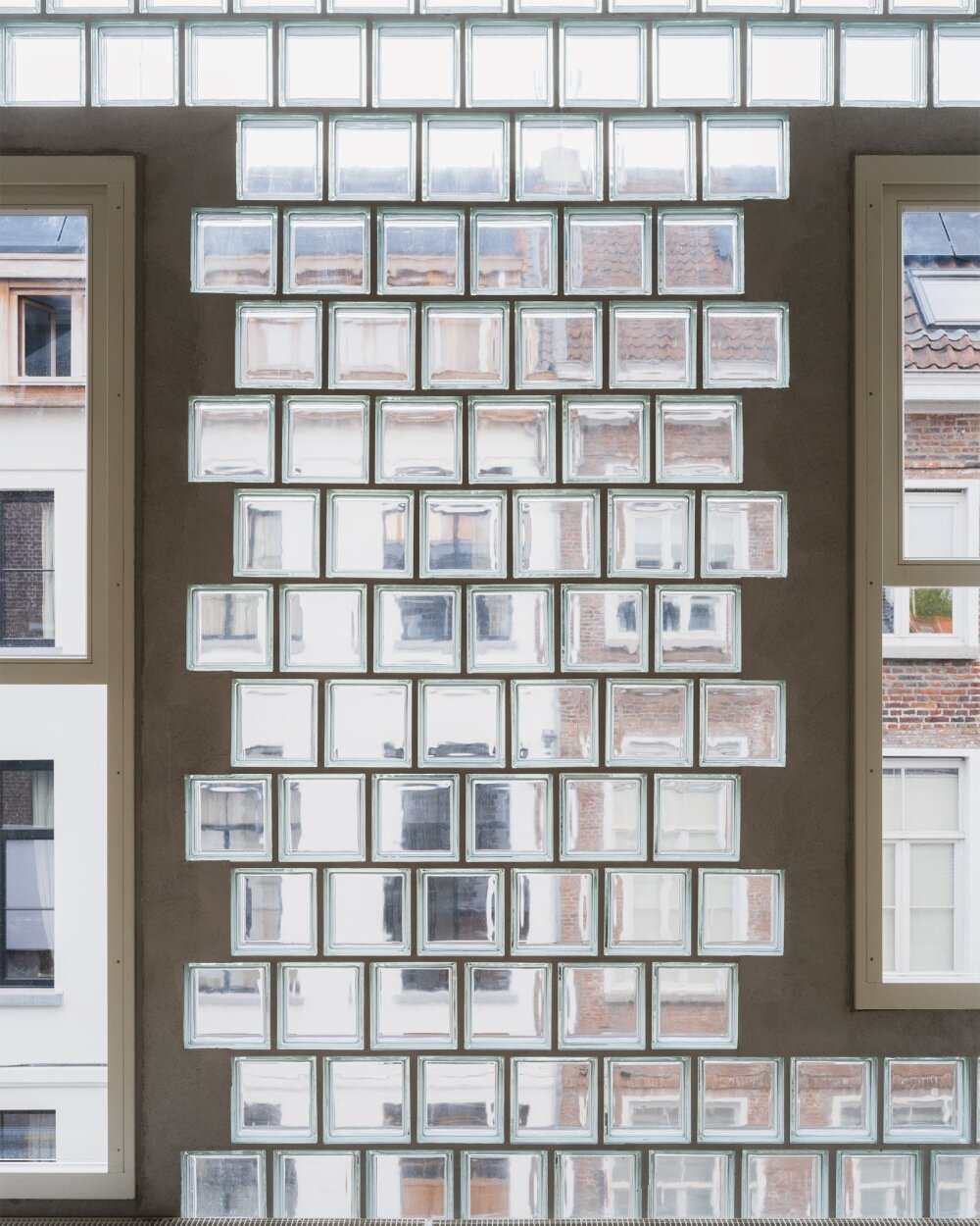delmulle delmulle's gradient brick facade shifts from terracotta to glass in amsterdam house