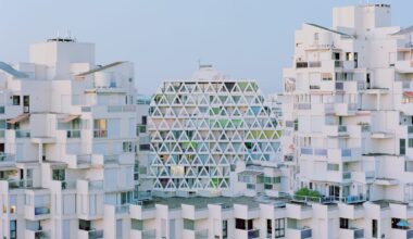 a modernist resort apartment complex in all-white against a blue sky