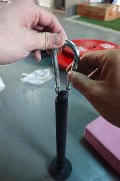 Close up of the carabiner connecting Liu's weights