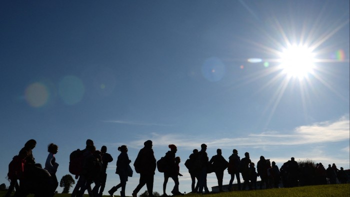 Migrants are on their way from the Austrian-German border to the first registration point of the German federal police near the small Bavarian village Wegscheid, southern Germany