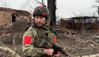 Russian army soldier walks along a ruined street of Malaya Loknya settlement
