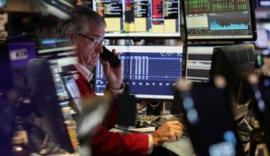 A trader works on the floor at the New York Stock Exchange in New York City