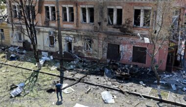 A man stands among debris next to a recruitment centre building damaged after a drone attack in Kharkiv