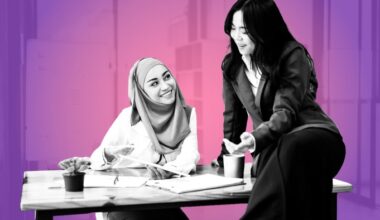 Two women chatting and smiling in the office